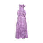 Violet polka-dot sleeveless dress with ruffled halter neckline and tied shoulder bow