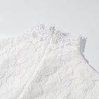 Close-up of white lace bodice with high neckline and scalloped detailing