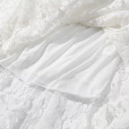 White lace dress overlay over satin-like inner skirt with gathered ruffle