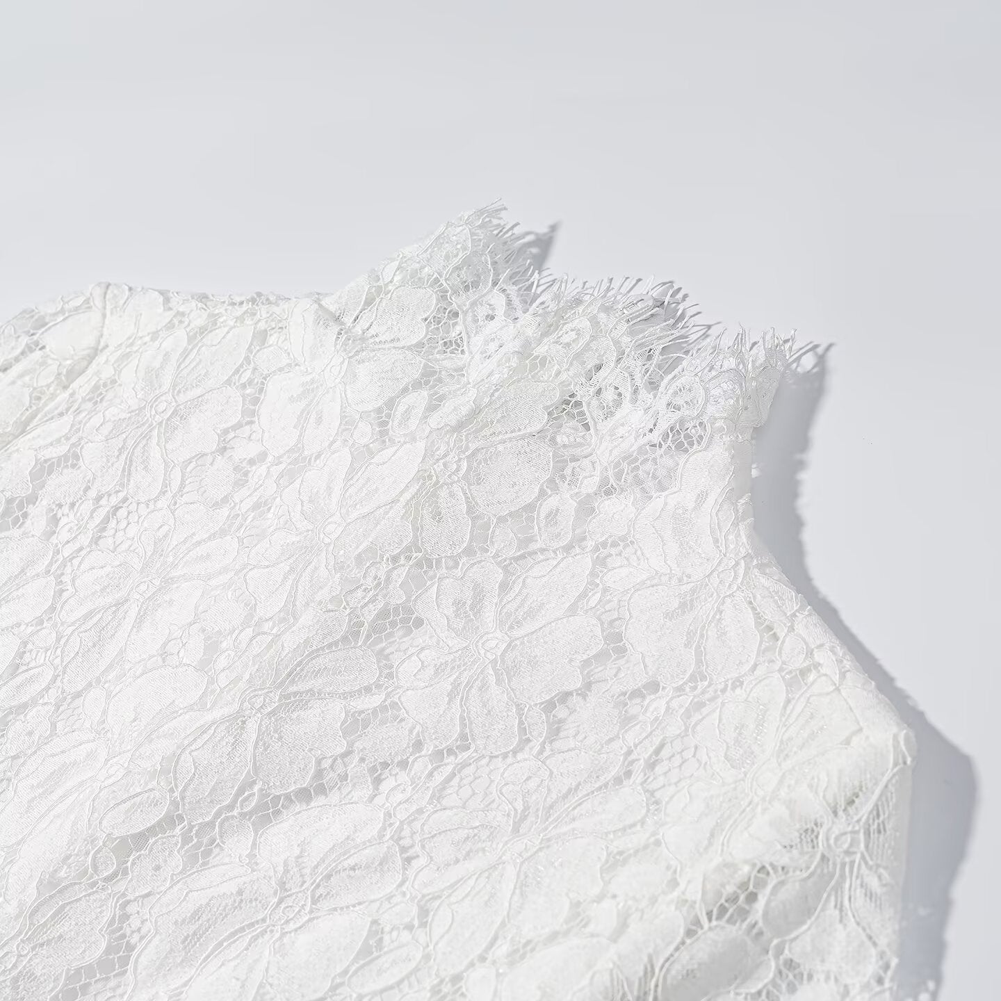 White lace bodice and shoulder detail with high collar and scalloped edges