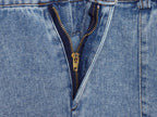Close-up of blue denim halter dress button placket with gold-tone zipper