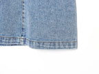 Hem of blue denim halter mini dress with frayed cuff edge