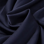 Navy satin-like fabric close view with soft folds and smooth texture