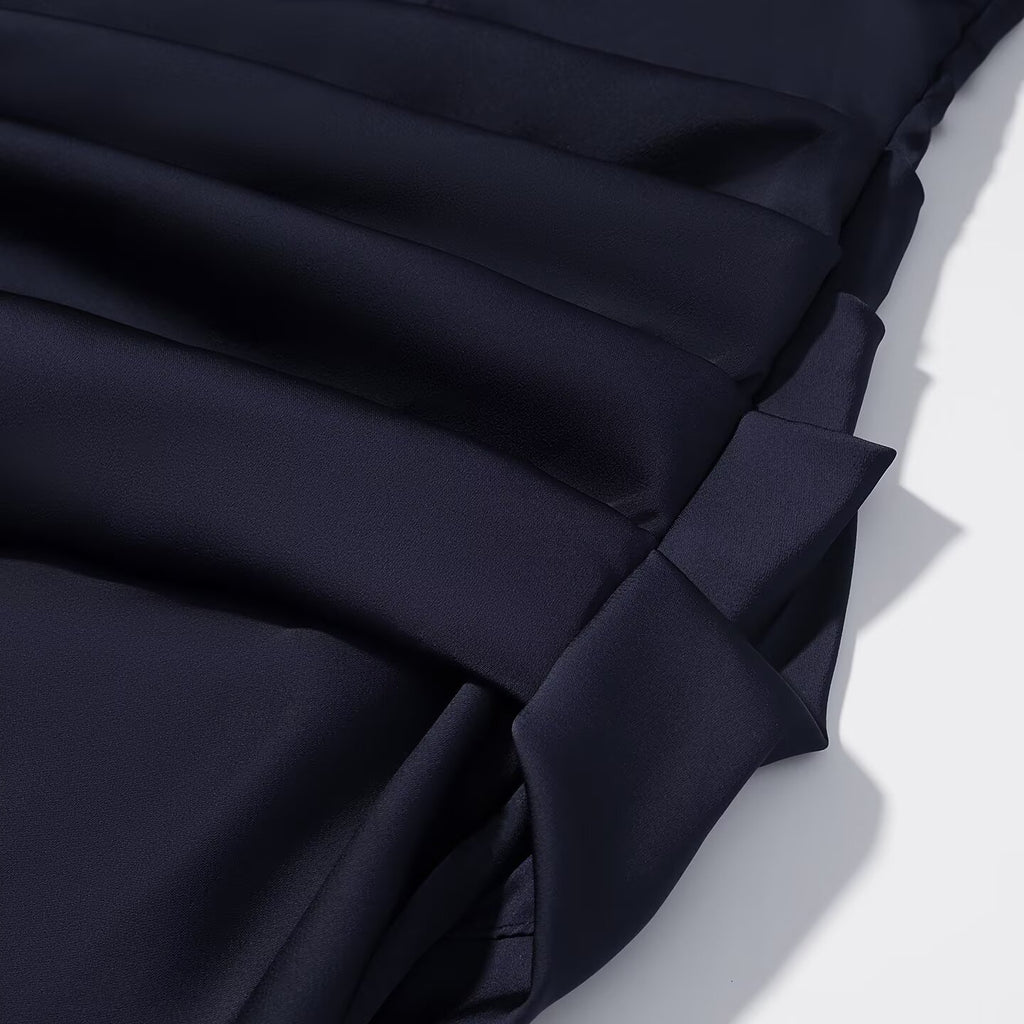 Navy blue pleated skirt with layered fabric panels and gathered detail