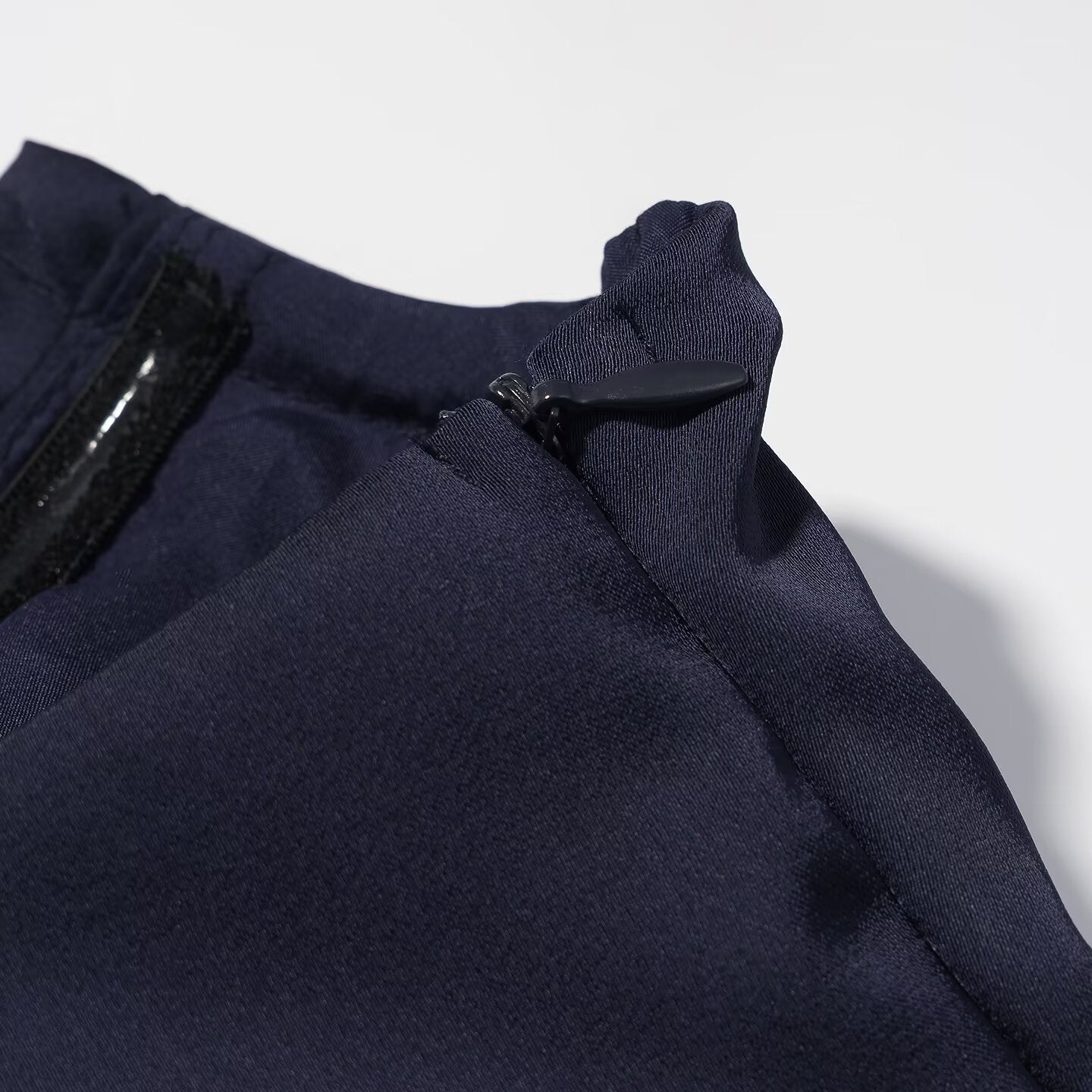 Navy blue sleeveless dress with stitched neckline and small snap detail