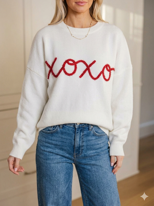 White knit pullover with red embroidered “hoxo” graphic on the front