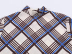 Close-up of multi plaid turtleneck collar with high neckline