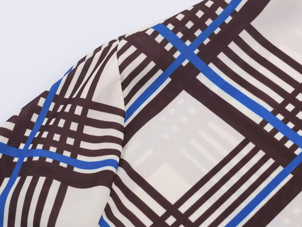 Close-up of multi plaid fabric on long sleeve of turtleneck shirt
