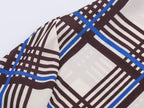 Close-up of multi plaid fabric on long sleeve of turtleneck shirt