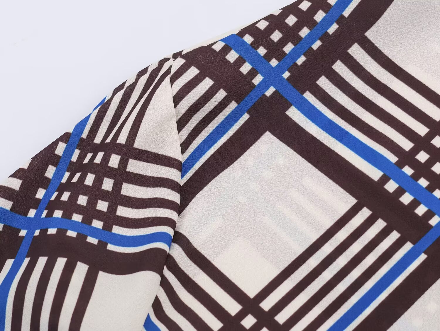 Close-up of multi plaid fabric on long sleeve of turtleneck shirt