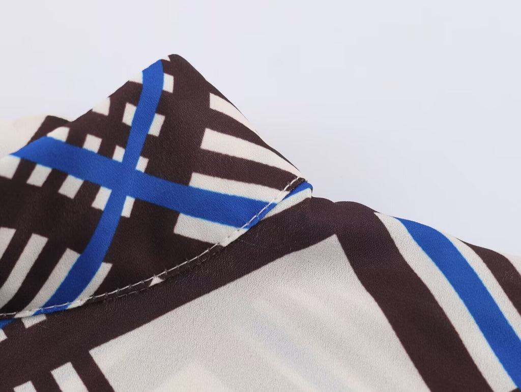 Close-up of seam detail at sleeve cuff on multi plaid turtleneck shirt