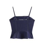 Deep blue denim women’s sling top with wide straps and peplum hem