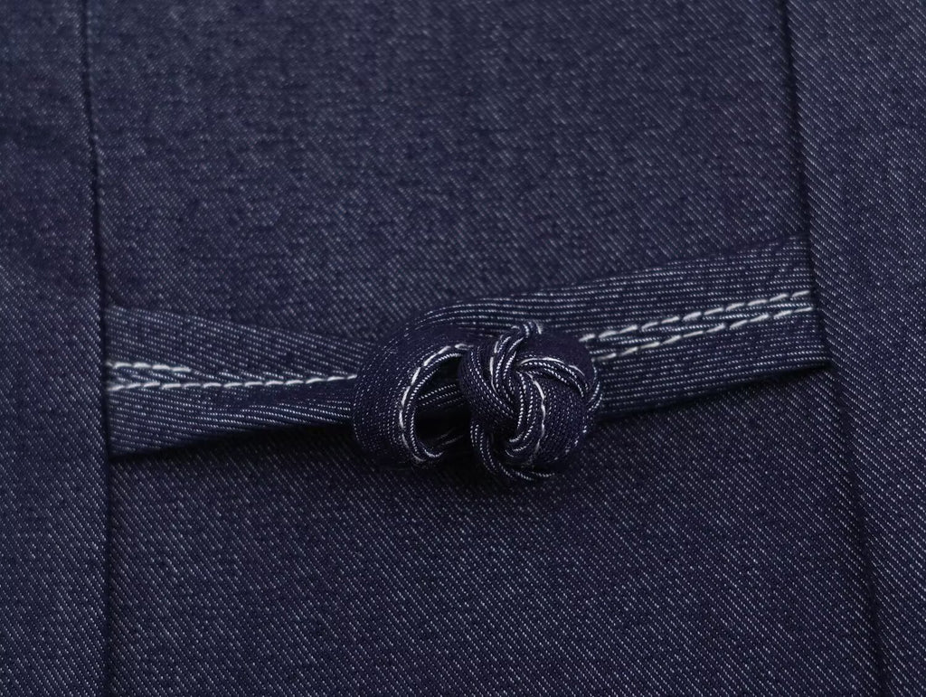 Deep blue denim button placket with twisted rope-button detail