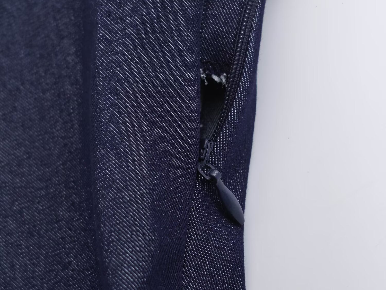 Deep blue denim side with zip tape and concealed pull tab