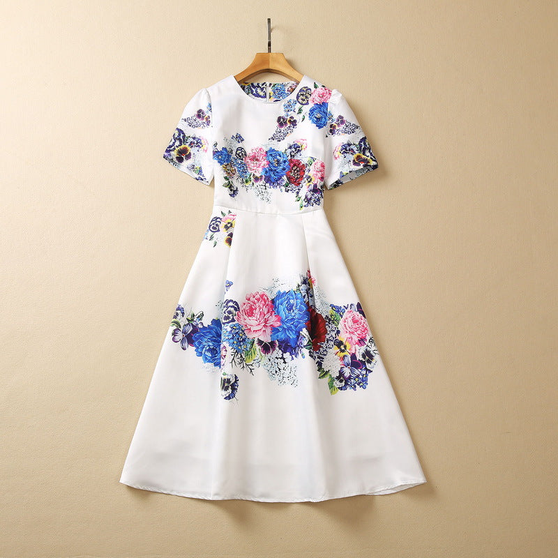 White floral sequin dress on hanger, short sleeves, gathered waist, full skirt with blue/pink print