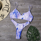Blue tie-dye bikini top and thong-style bottom set, laid flat