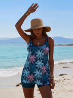 Blue floral one-piece swimsuit with scoop neck, sleeveless design, teal swim shorts