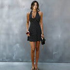 Black halter V-neck mini dress with white polka dots