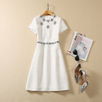 Beige sequin mini dress with jeweled floral neckline and short sleeves