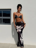 Black halter bikini with white floral print and matching long skirt, front view