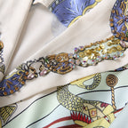 Sequin and bead-embellished neckline with gold trim on printed dress, multicolor accents.