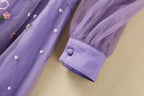 Purple long-sleeve tulle dress with contrast cuff detail and embroidered accents