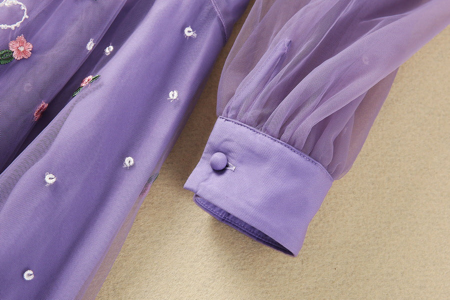 Purple long-sleeve tulle dress with contrast cuff detail and embroidered accents