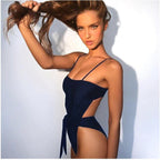 Navy one-piece swimsuit with thin straps and side waist tie