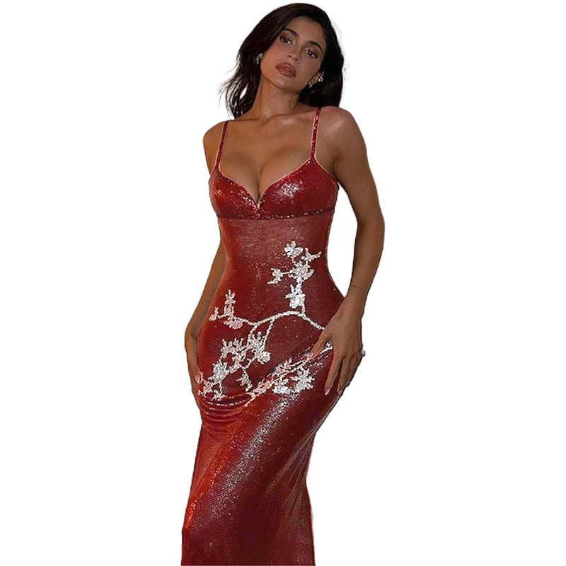 Red sequin V-neck maxi dress with spaghetti straps, fitted silhouette, white reindeer pattern