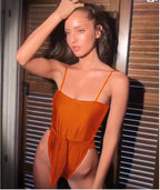 Orange one-piece swimsuit with thin straps and ruched waist front