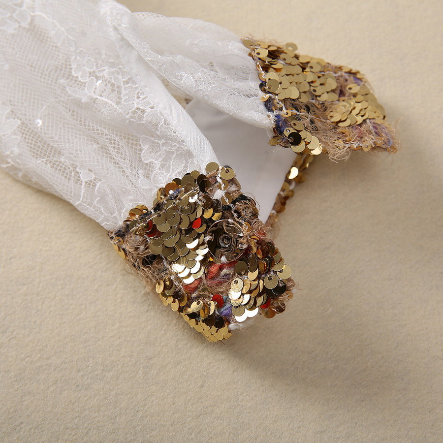 Gold sequin detail on sheer lace sleeve cuff with glittering embellishment