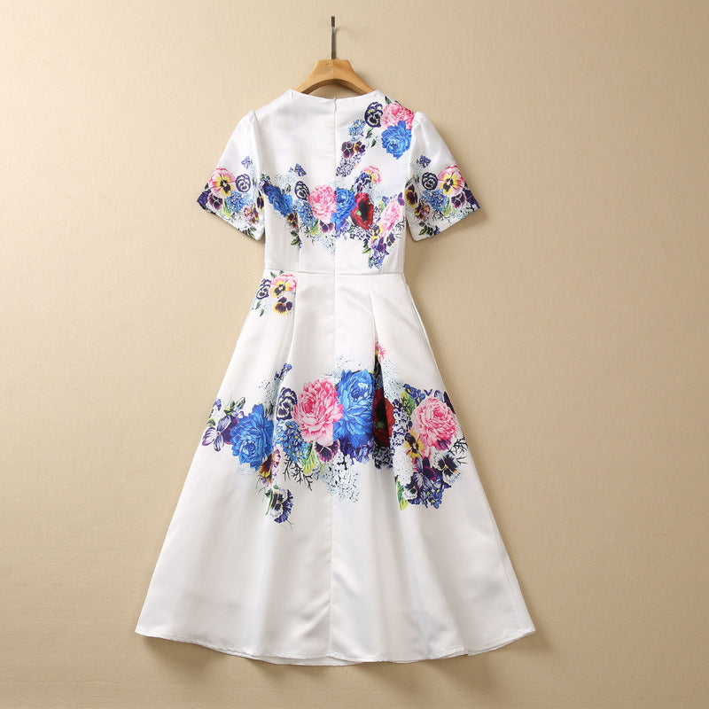 White floral sequin dress, short sleeves and full skirt with bold blue and pink floral pattern