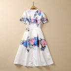 White floral sequin dress, short sleeves and full skirt with bold blue and pink floral pattern