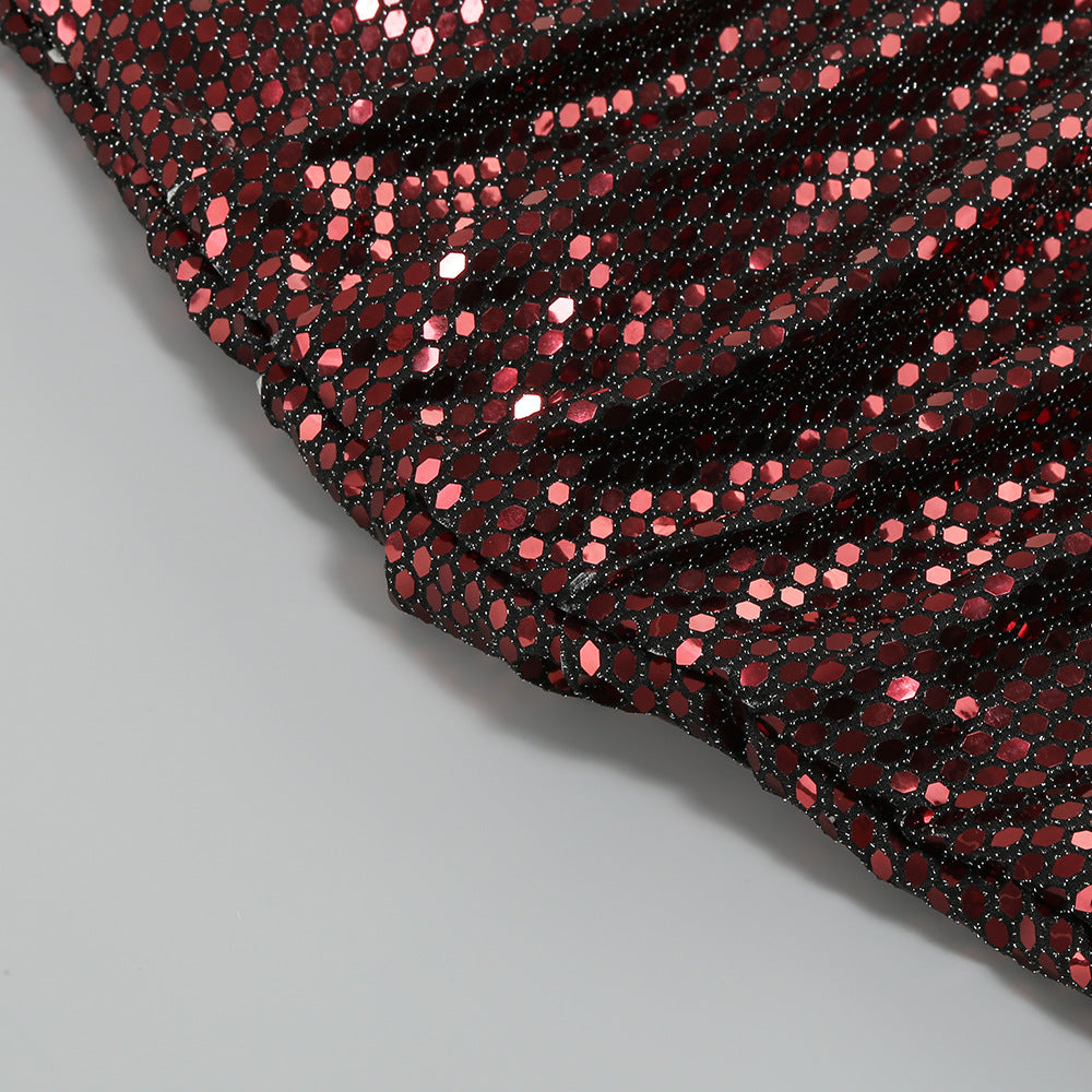 Close-up of rose gold sequin fabric on one-shoulder mini dress, textured sparkle