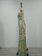 Women’s green sequin maxi dress on mannequin, side view, spaghetti straps, ornate pattern