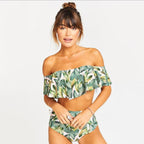 Off-shoulder one-piece swimsuit with green tropical leaf print and ruffled neckline