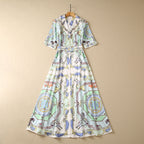 Women's sequin short-sleeve midi dress in multicolor illustrated print with tied waist belt.