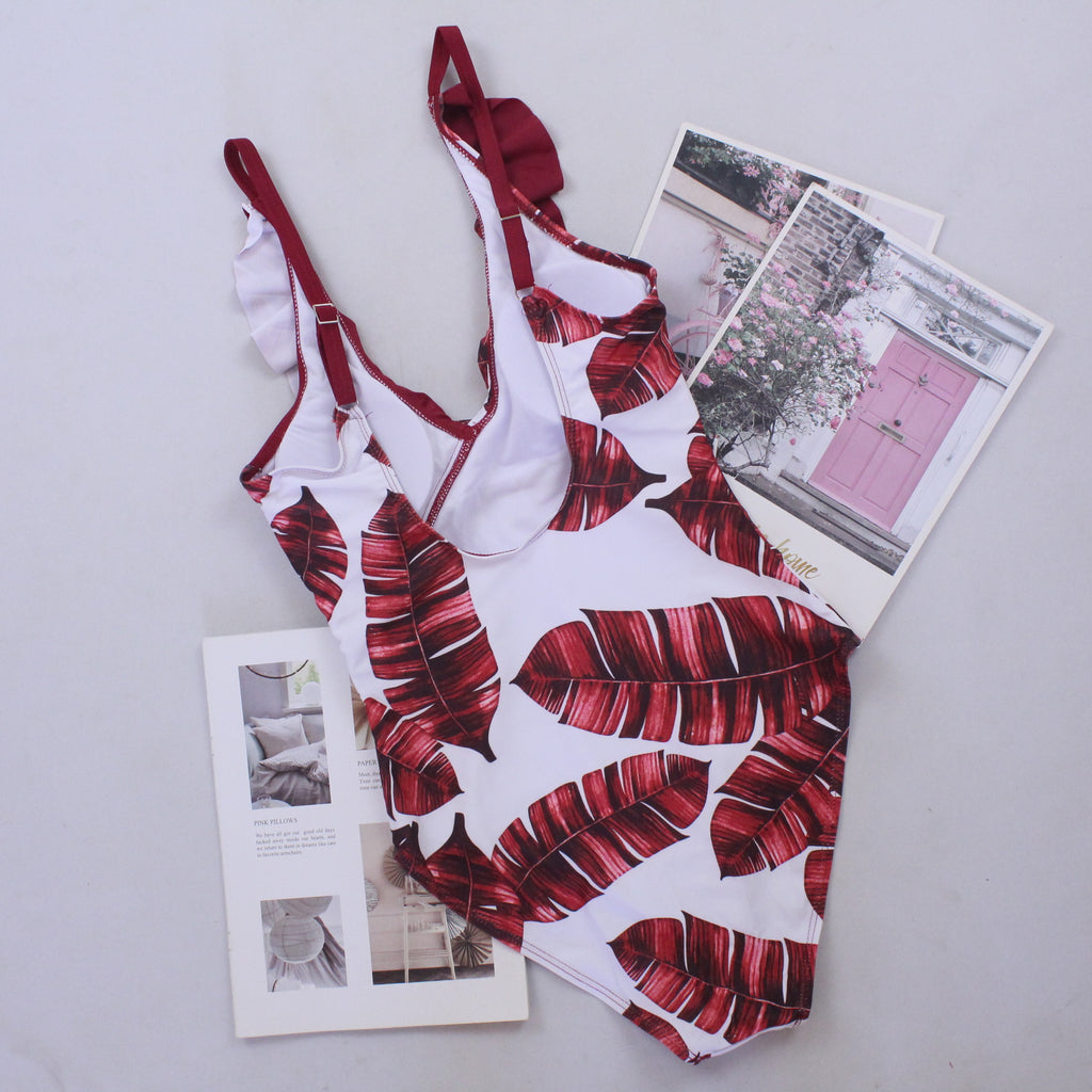 Red-and-white tropical print one-piece swimsuit with V-neck straps