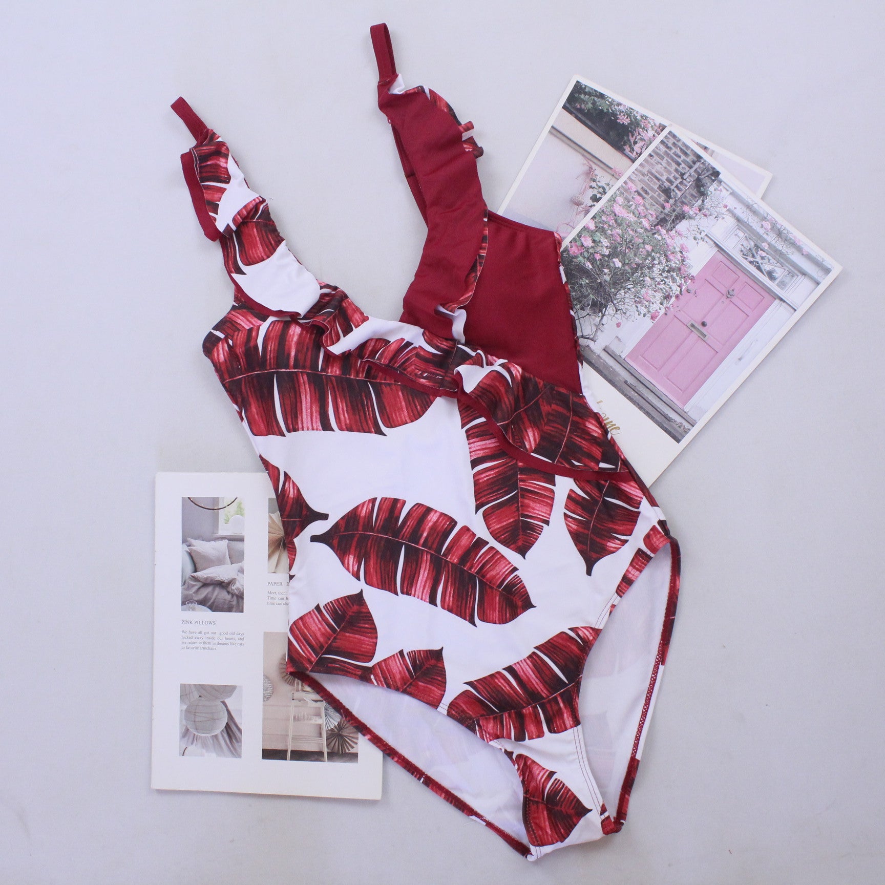 Red-and-white tropical print one-piece swimsuit, V-neck and tied straps