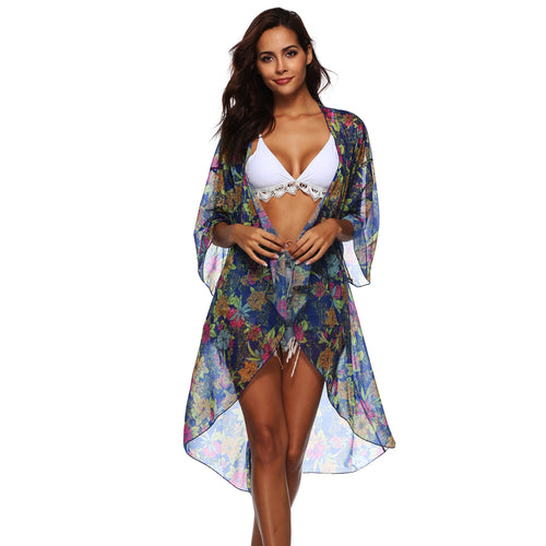 White asymmetrical bikini set with floral sheer cover-up kimono, standing pose