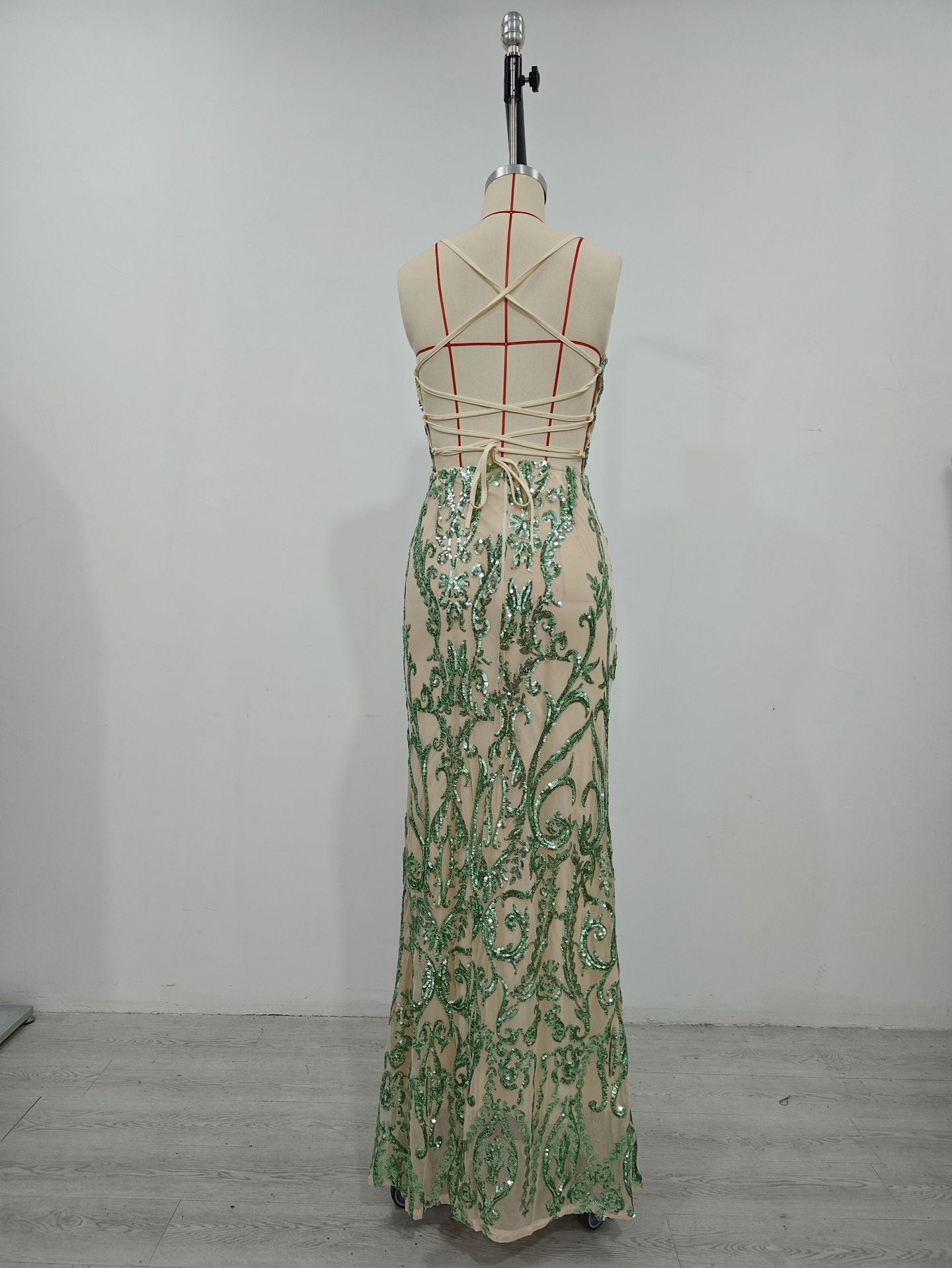 Women’s green sequin maxi dress on mannequin, ornate pattern, spaghetti straps