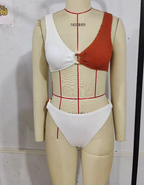 Mannequin display of rust-and-white textured knit bikini top and high-cut bottom briefs
