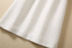 Beige sequin textured fabric skirt hem with subtle sparkle