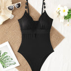 Black textured one-piece swimsuit with V neckline and adjustable spaghetti straps