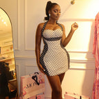 Women's halter wrap mini dress, white base with black polka dots and fitted corset panel