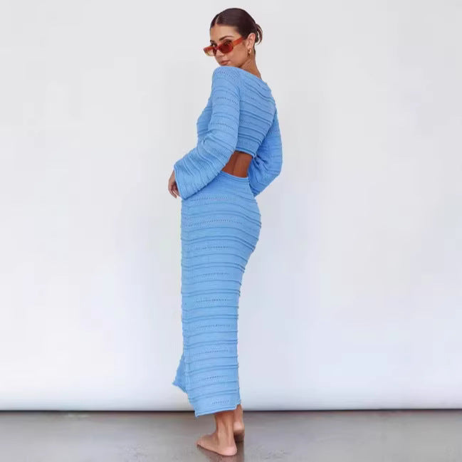 Sky blue maxi knit dress, long sleeves, V-neck, ribbed textured column shape.