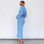 Sky blue maxi knit dress, long sleeves, V-neck, ribbed textured column shape.