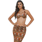 Women’s lace halter dress, orange floral print with bow halter and layered chain details.
