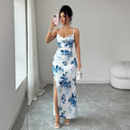 Maxi sling dress with white base and blue floral print, ruched bodice, side slit