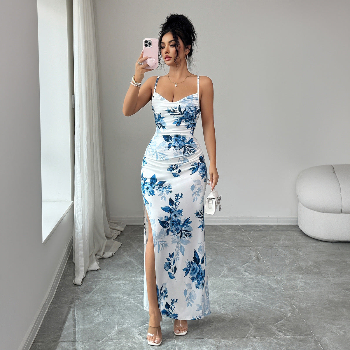Maxi sling dress with white base and blue floral print, ruched bodice, side slit